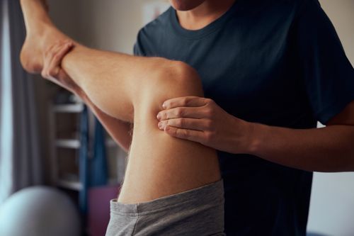 Close-up of sports chiropractor hands giving therapy treatment to a patient.