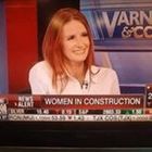 Woman on a news set discussing