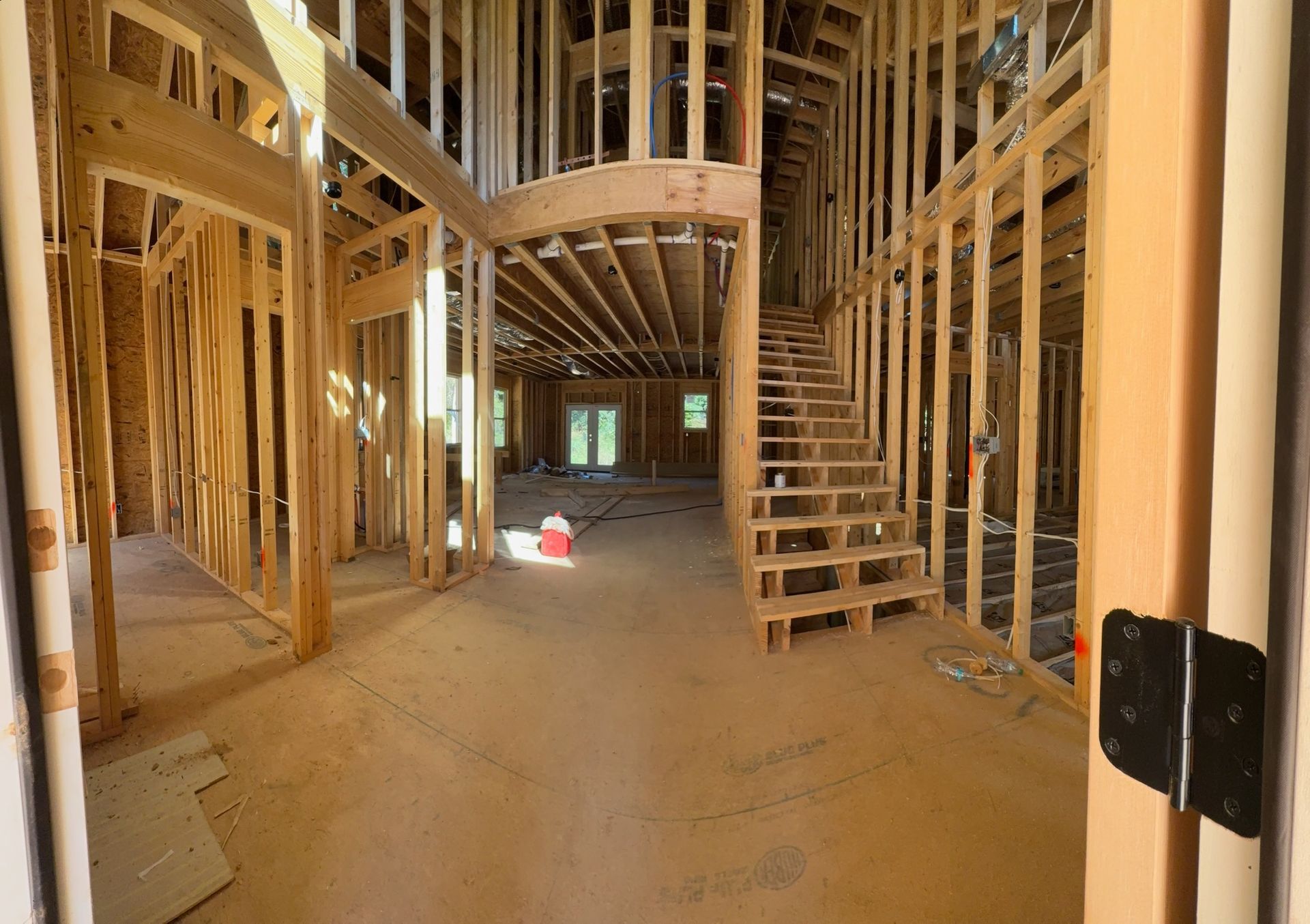 A house is being built with wooden beams and stairs.