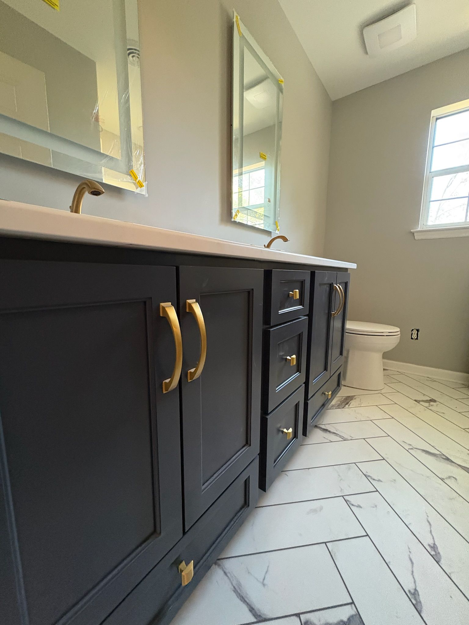 A bathroom with a sink , toilet , and mirror.