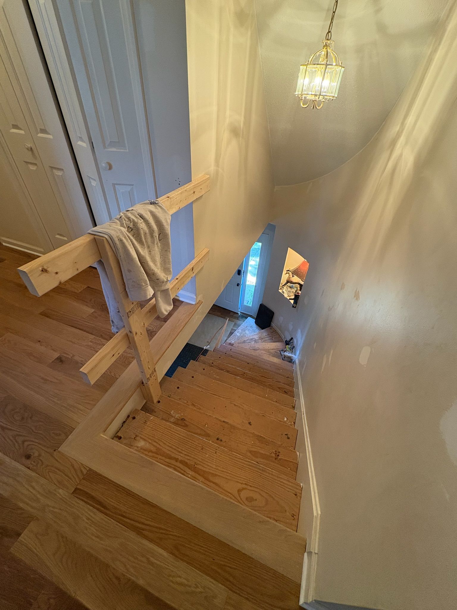A wooden staircase is being built in a house.