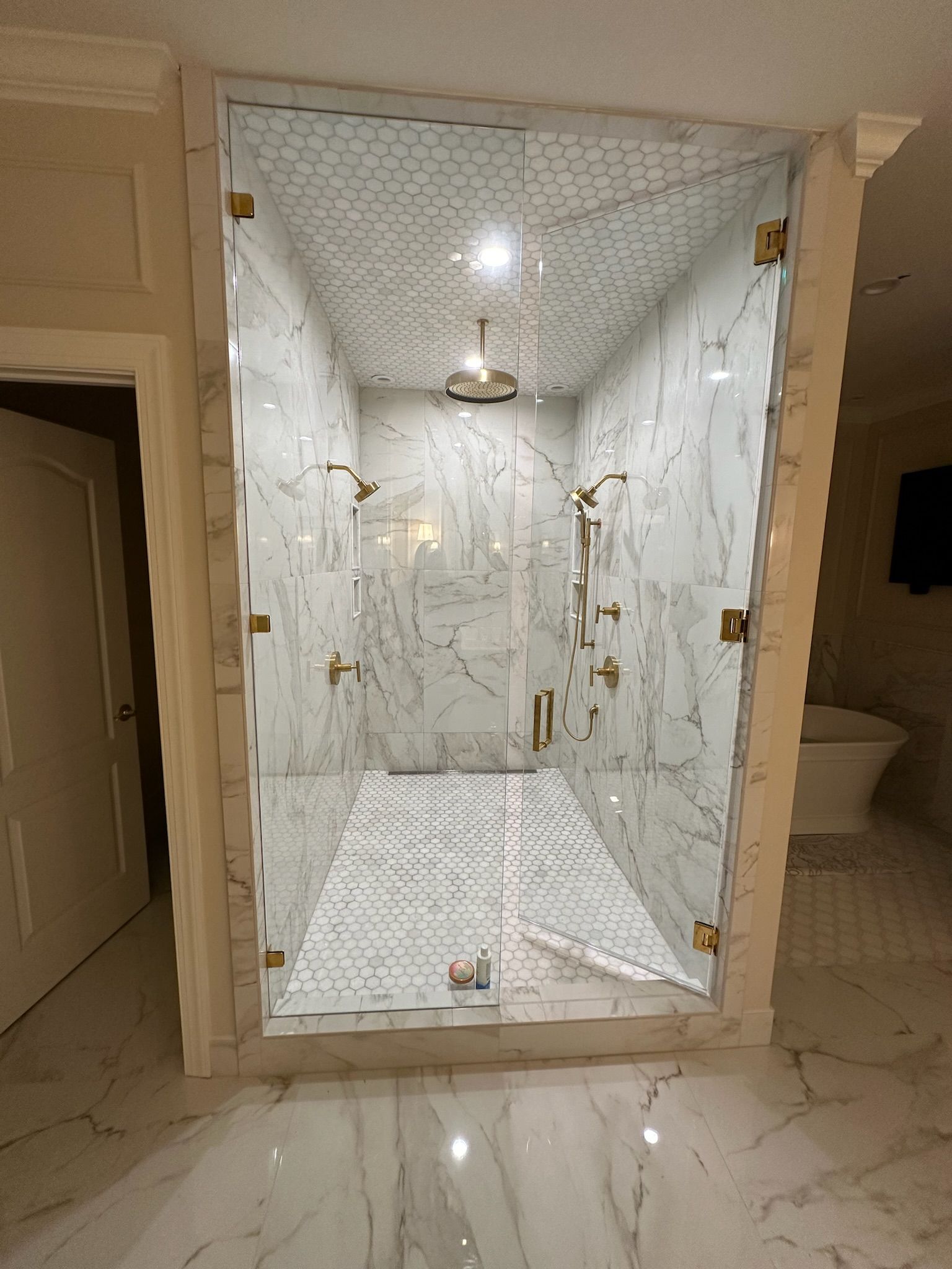 A bathroom with a walk in shower and a bathtub.
