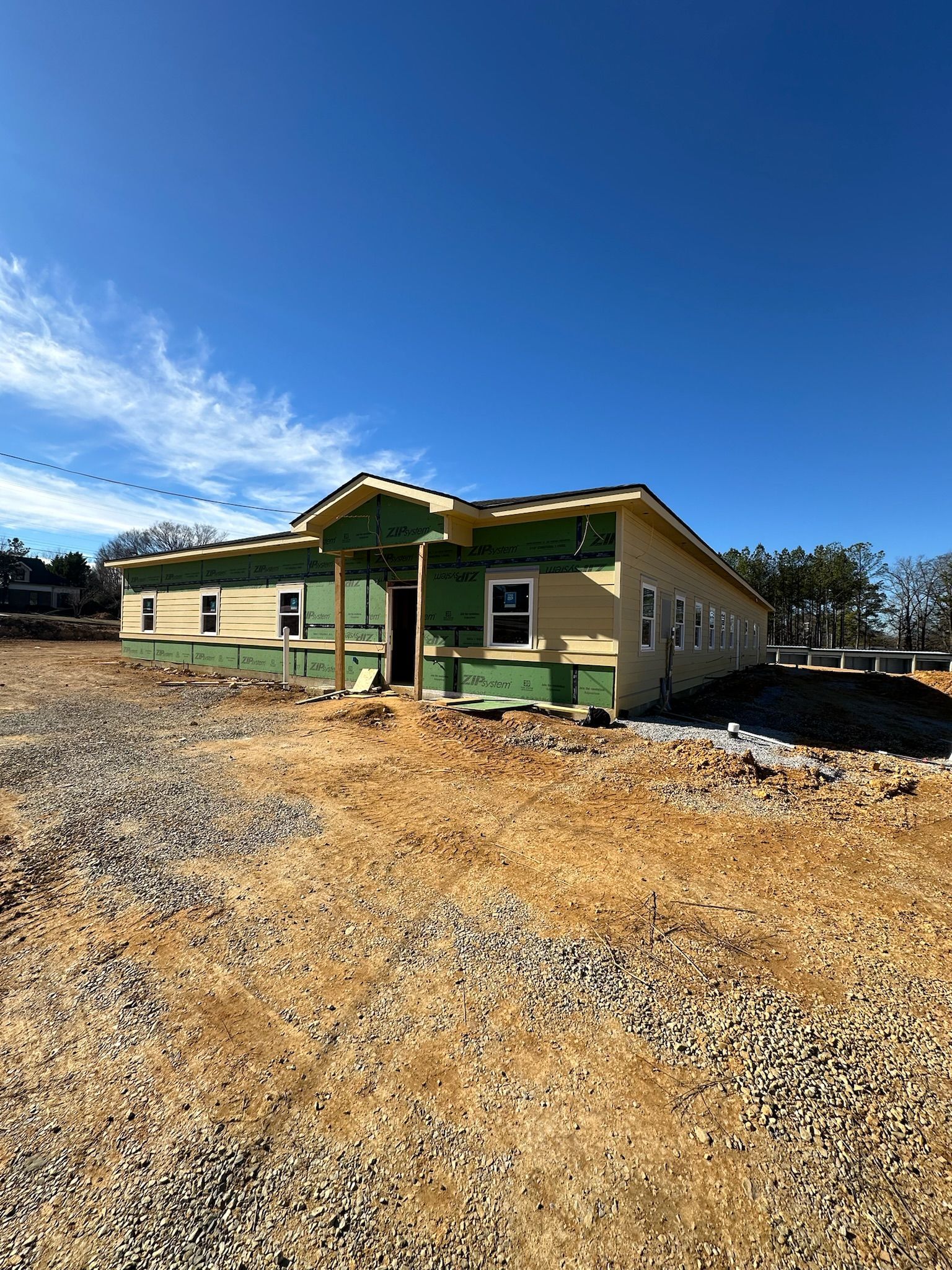 A house is being built in a dirt field.