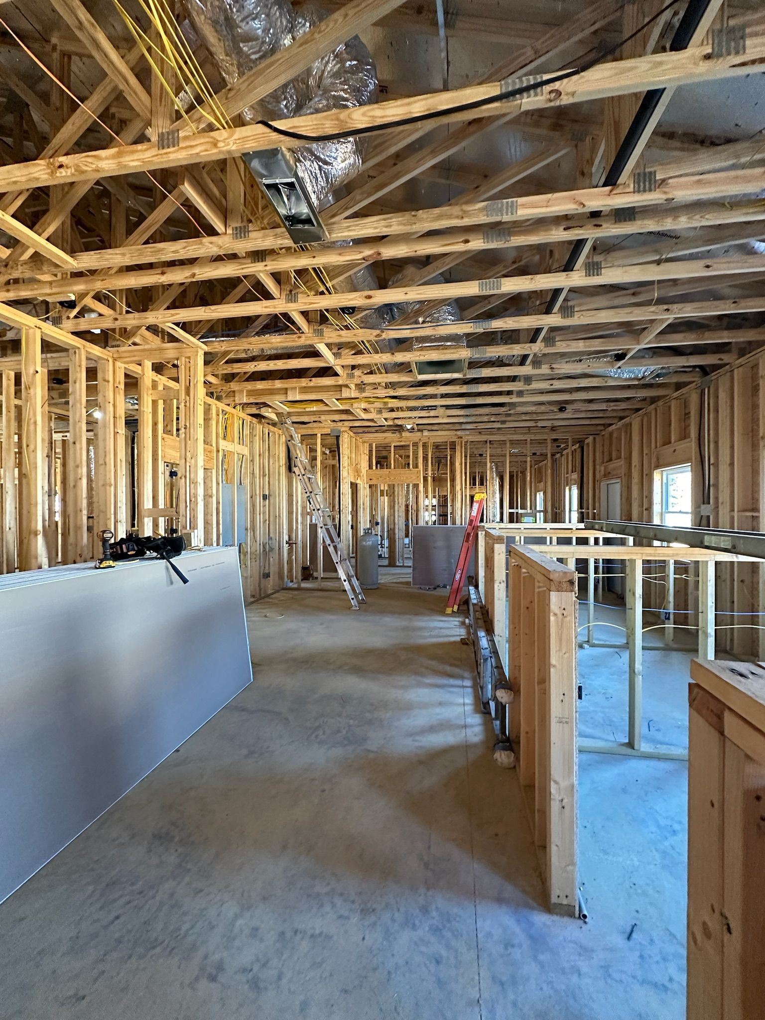 The inside of a building under construction with a lot of wooden beams.