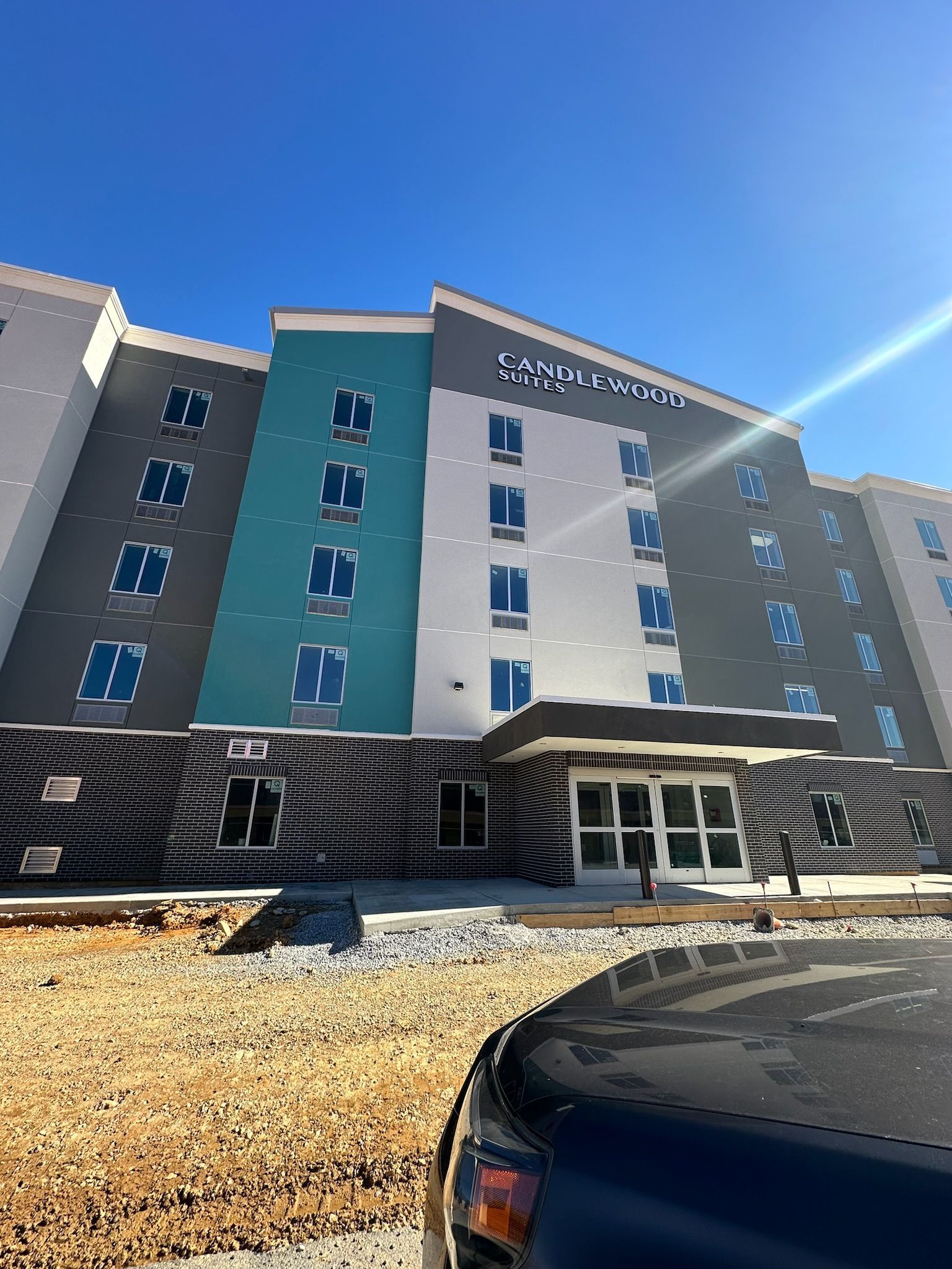 A large building with a lot of windows and a car parked in front of it.