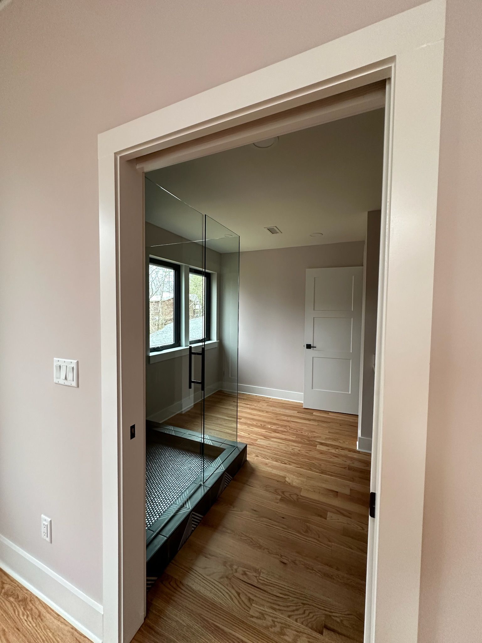 A room with a sliding glass door leading to a bathroom.