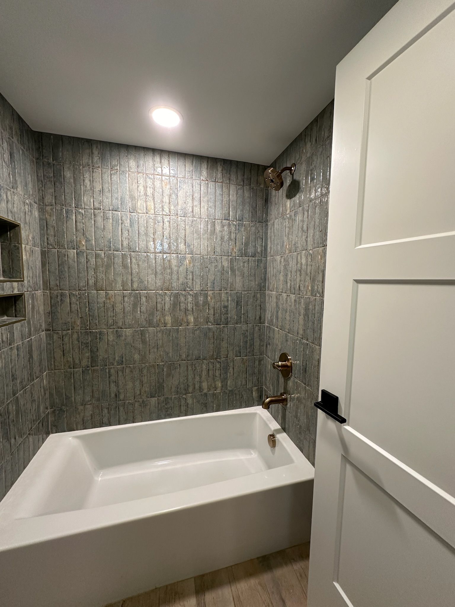 A bathroom with a bathtub and a shower.