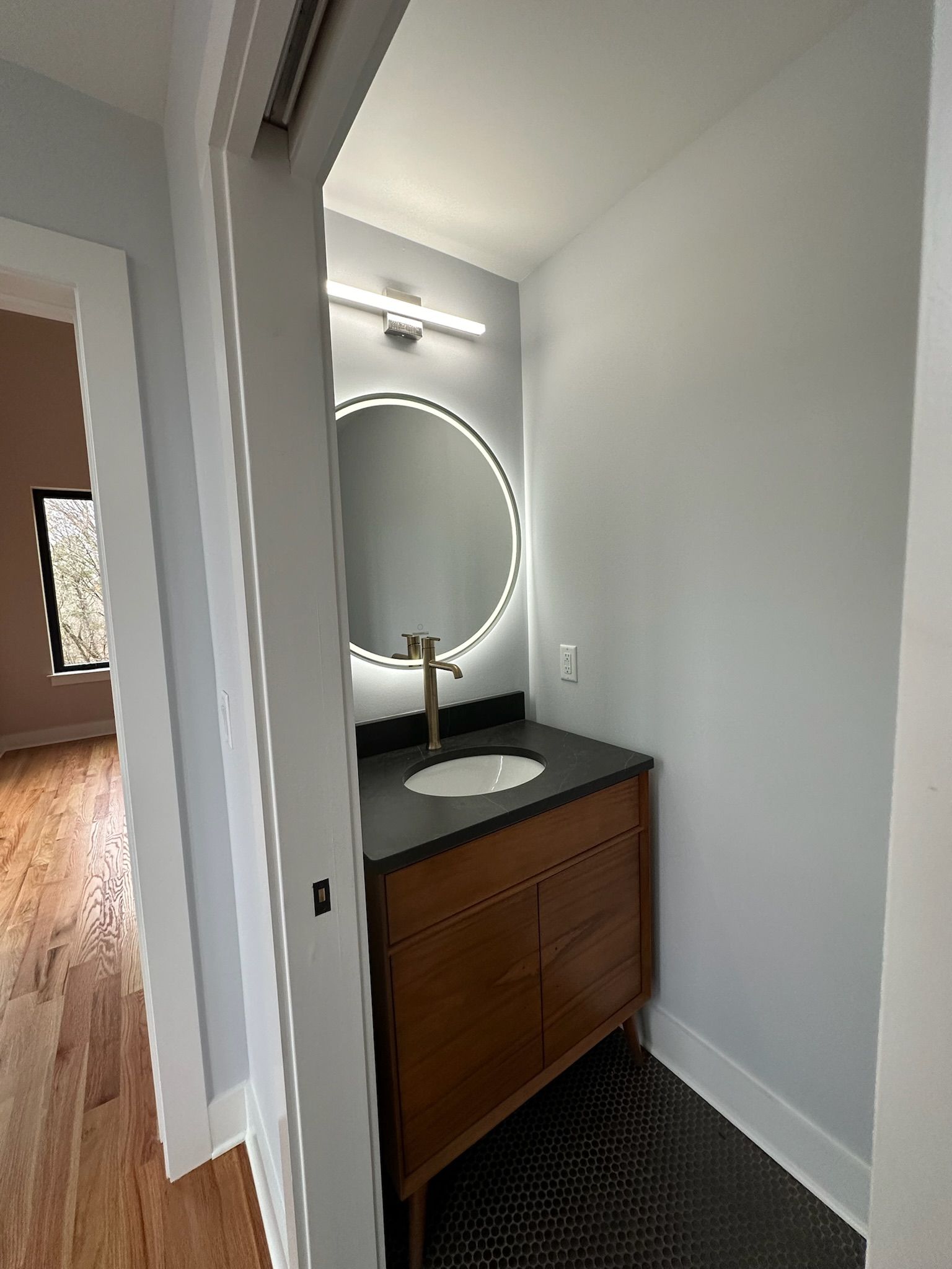 There is a bathroom with a sink and a mirror.