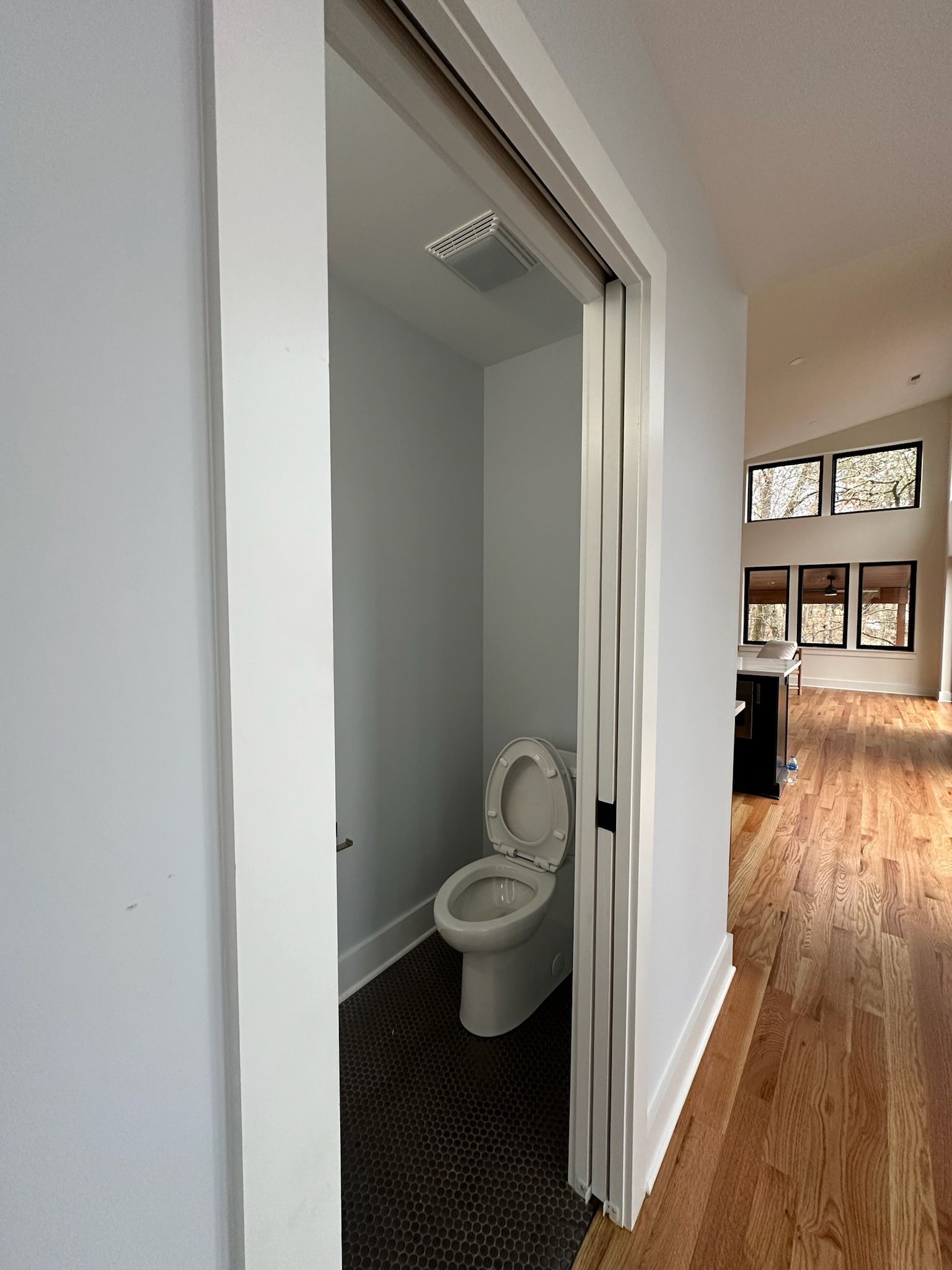 A bathroom with a toilet and a sliding door