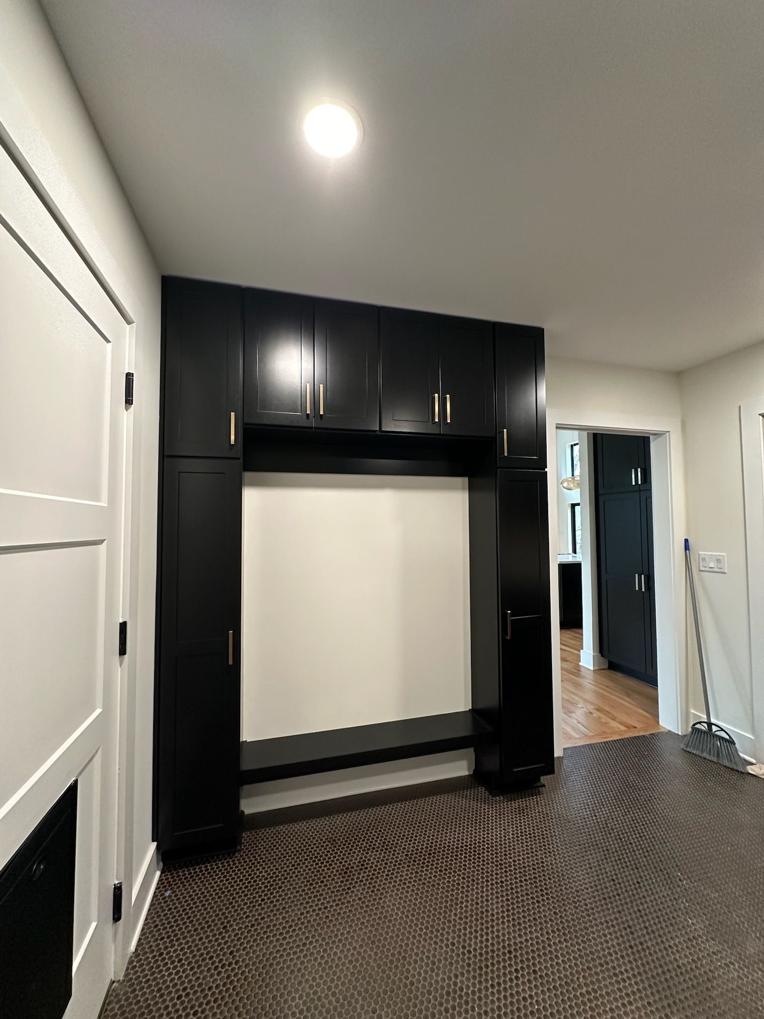 A room with black cabinets and a carpeted floor.