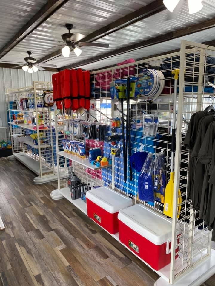 A store filled with lots of items including coolers and life jackets.