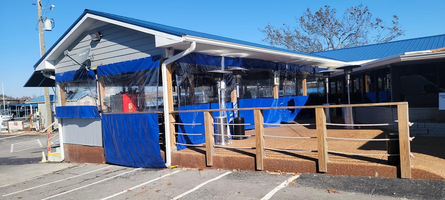 A blue and white building with a wooden fence in front of it.