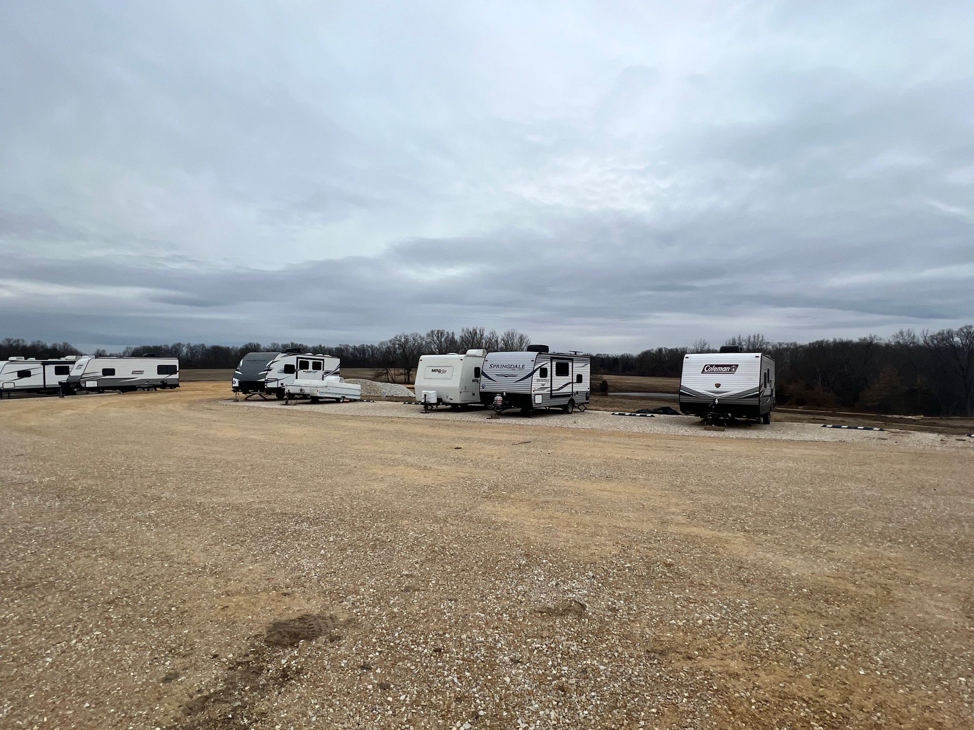 RVs parked on gravel lot