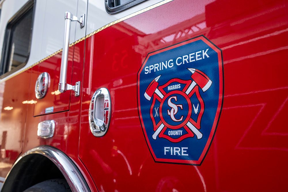 Close-up of a red fire truck with the Spring Creek Fire department emblem.