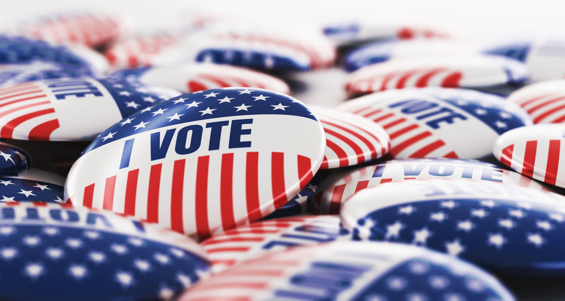 A pile of i vote buttons with american flags on them