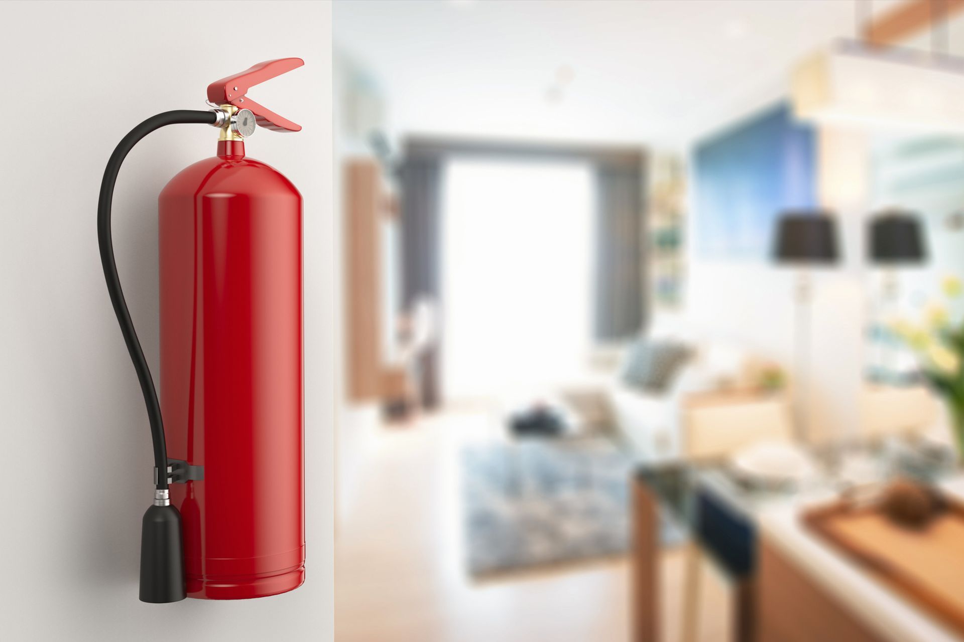 Red fire extinguisher on wall in a blurred living room interior