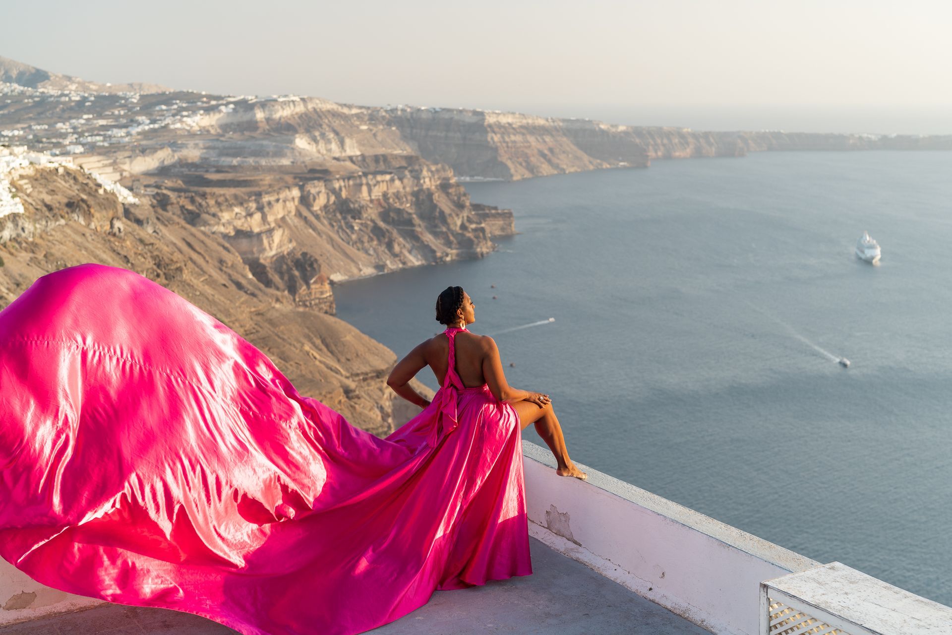 Black women taking a Flying Dress Photoshoot in Santorini