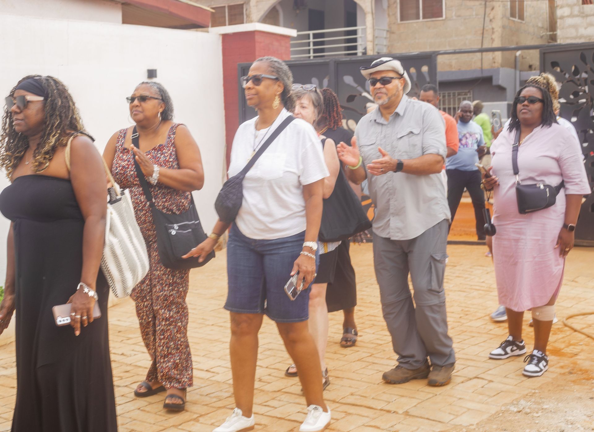 black women travelers walking into their naming ceremony in Accra