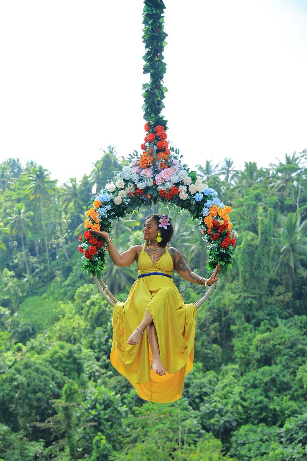 Traveler on Bali Swing soaring above Ubud rice terraces and tropical jungle