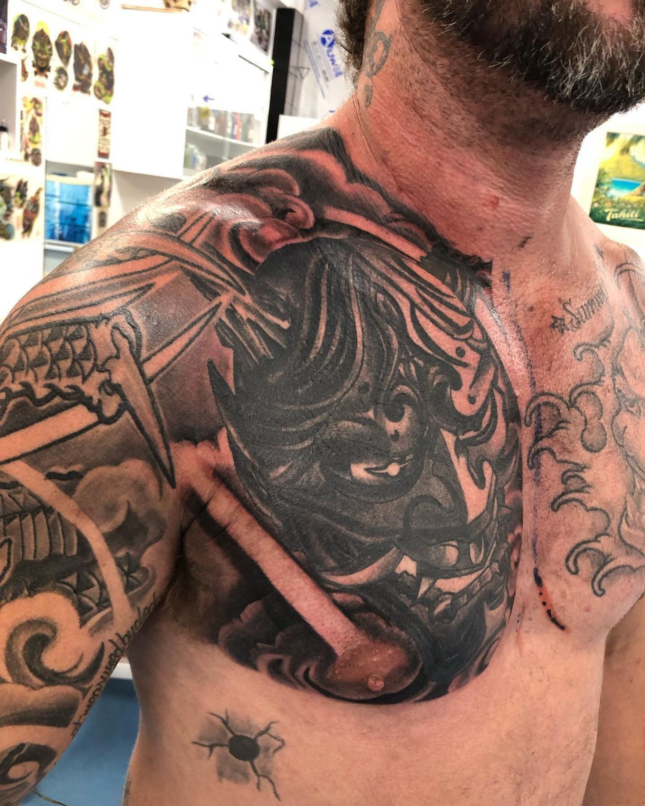 A Man With a Tattoo on His Arm is Laying on a Table — La Bomba Loca Tattoo in Cairns City, QLD