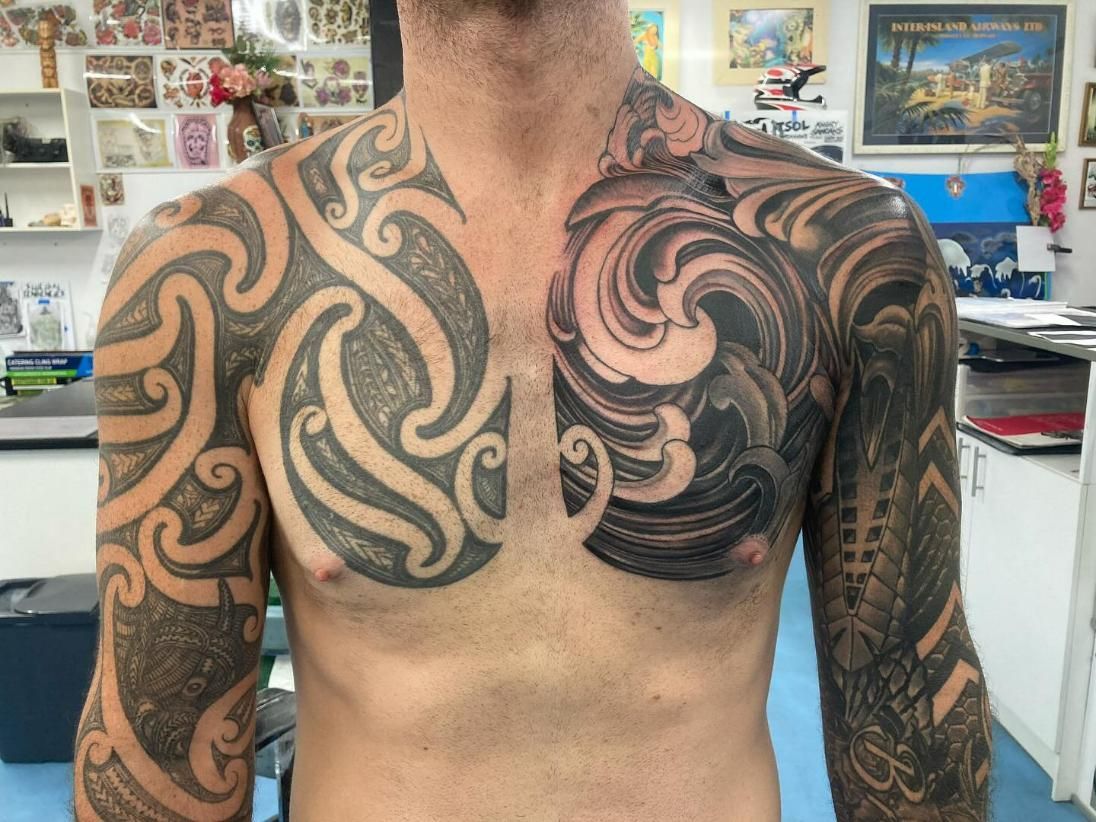 A Man With a Tattoo on His Chest and Sleeves — La Bomba Loca Tattoo in Cairns City, QLD