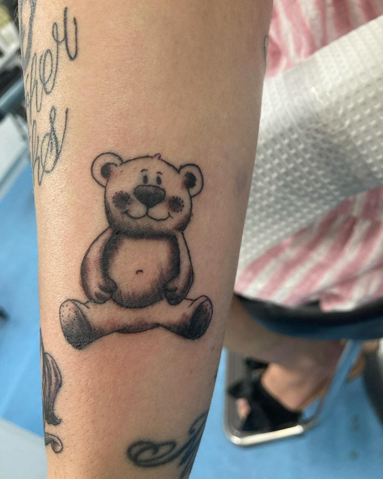 A Woman Has a Tattoo of a Teddy Bear on Her Arm — La Bomba Loca Tattoo in Cairns City, QLD