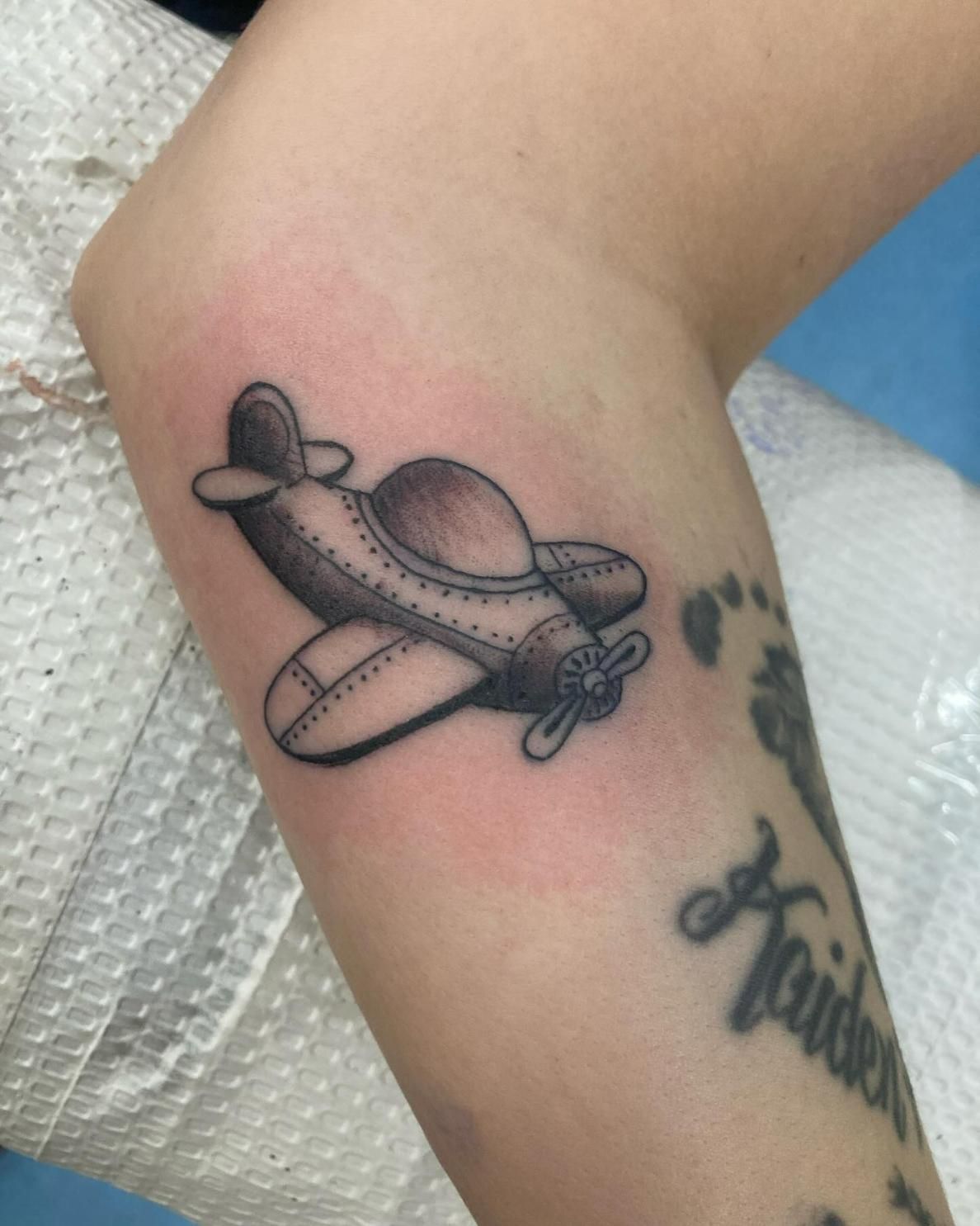 A Person Has a Tattoo of an Airplane on Their Arm — La Bomba Loca Tattoo in Edmonton, QLD