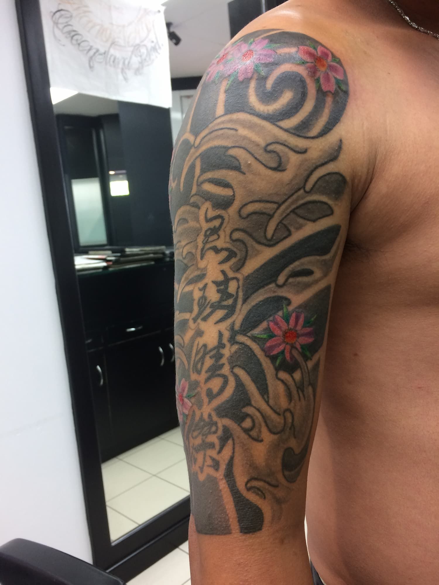 A Man Without a Shirt Has a Tattoo on His Arm — La Bomba Loca Tattoo in Cairns City, QLD