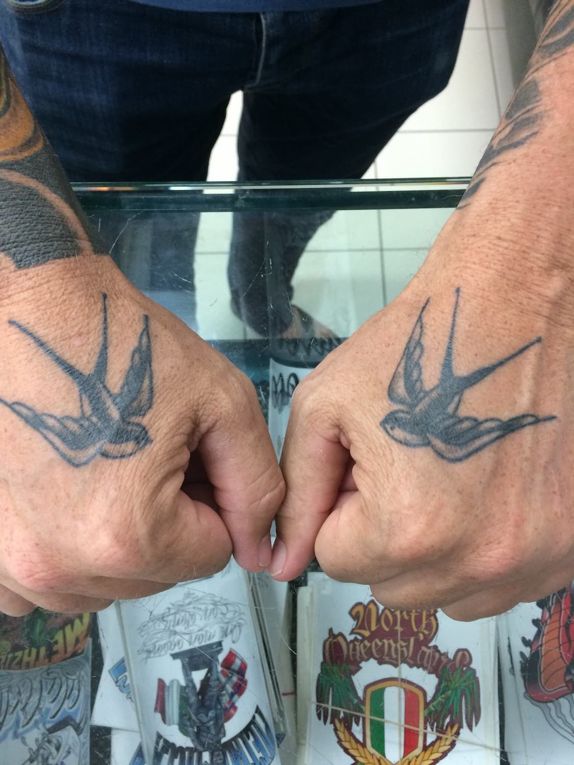 A Man Has Two Birds Tattooed on His Hands — La Bomba Loca Tattoo in Cairns City, QLD