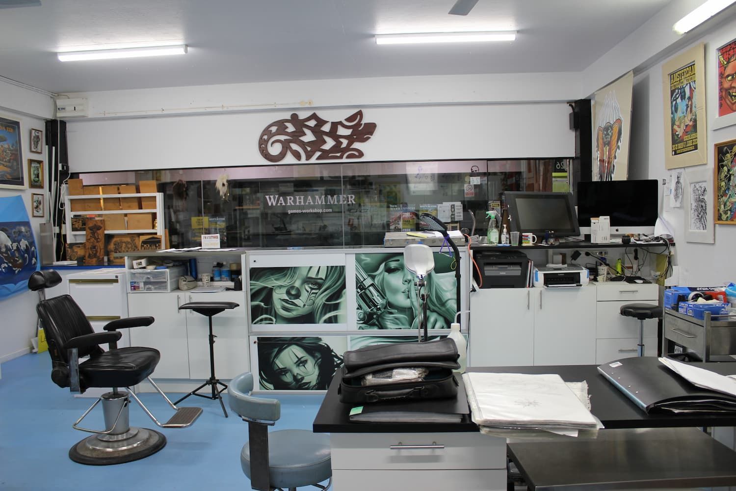 A Room with a Barber Chair and a desk with a Computer on it — La Bomba Loca Tattoo in Cairns City, QLD