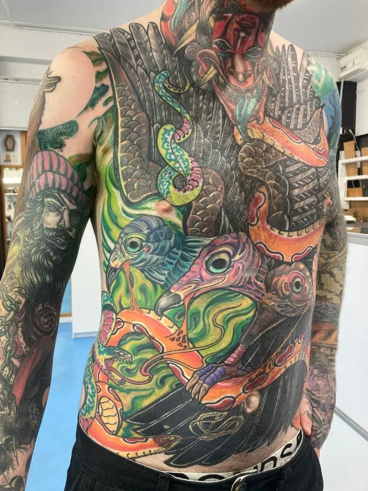 A Man With a Tattoo on His Chest and Shoulder — La Bomba Loca Tattoo in Cairns City, QLD