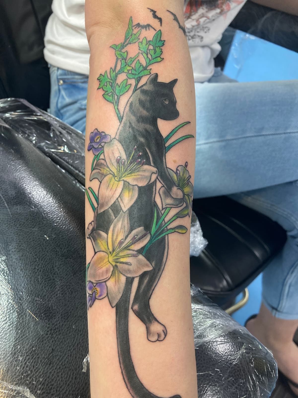 A Tattoo of a Black Panther Surrounded by Flowers — La Bomba Loca Tattoo in Cairns City, QLD