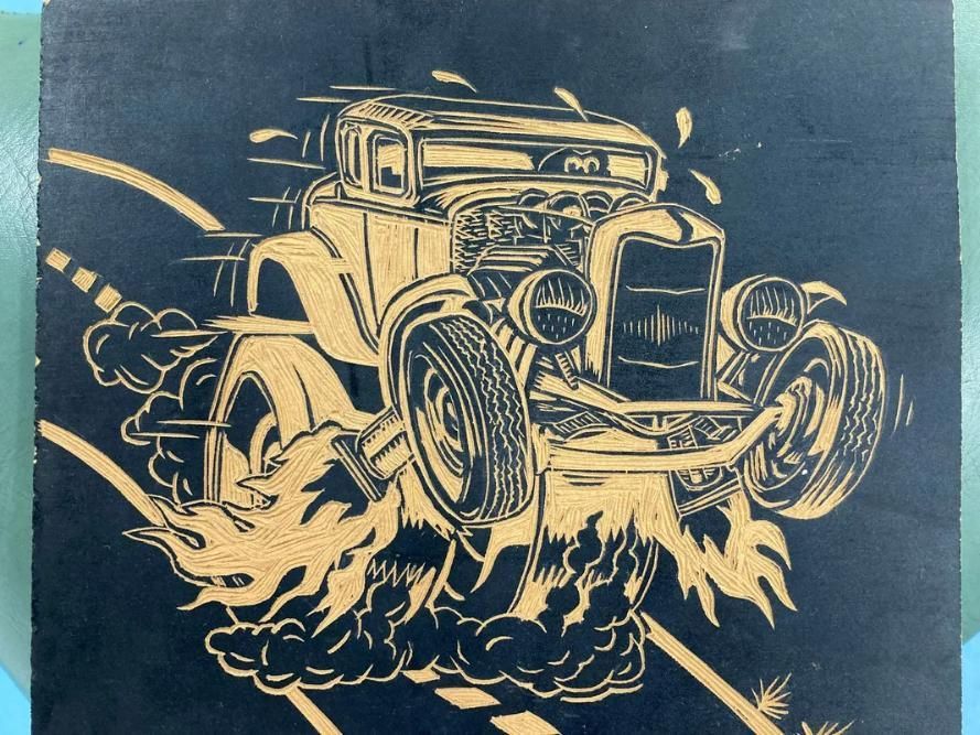 A Black and Gold Drawing of a Hot Rod on a Road — La Bomba Loca Tattoo in Cairns City, QLD