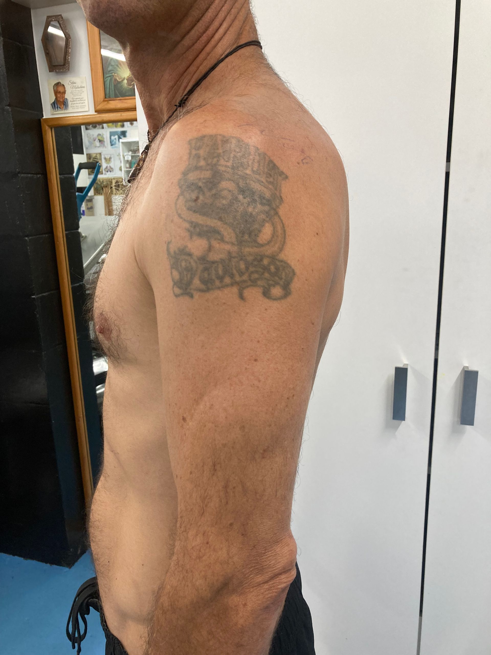 A Man Without a Shirt Has a Tattoo on His Arm — La Bomba Loca Tattoo in Cairns City, QLD