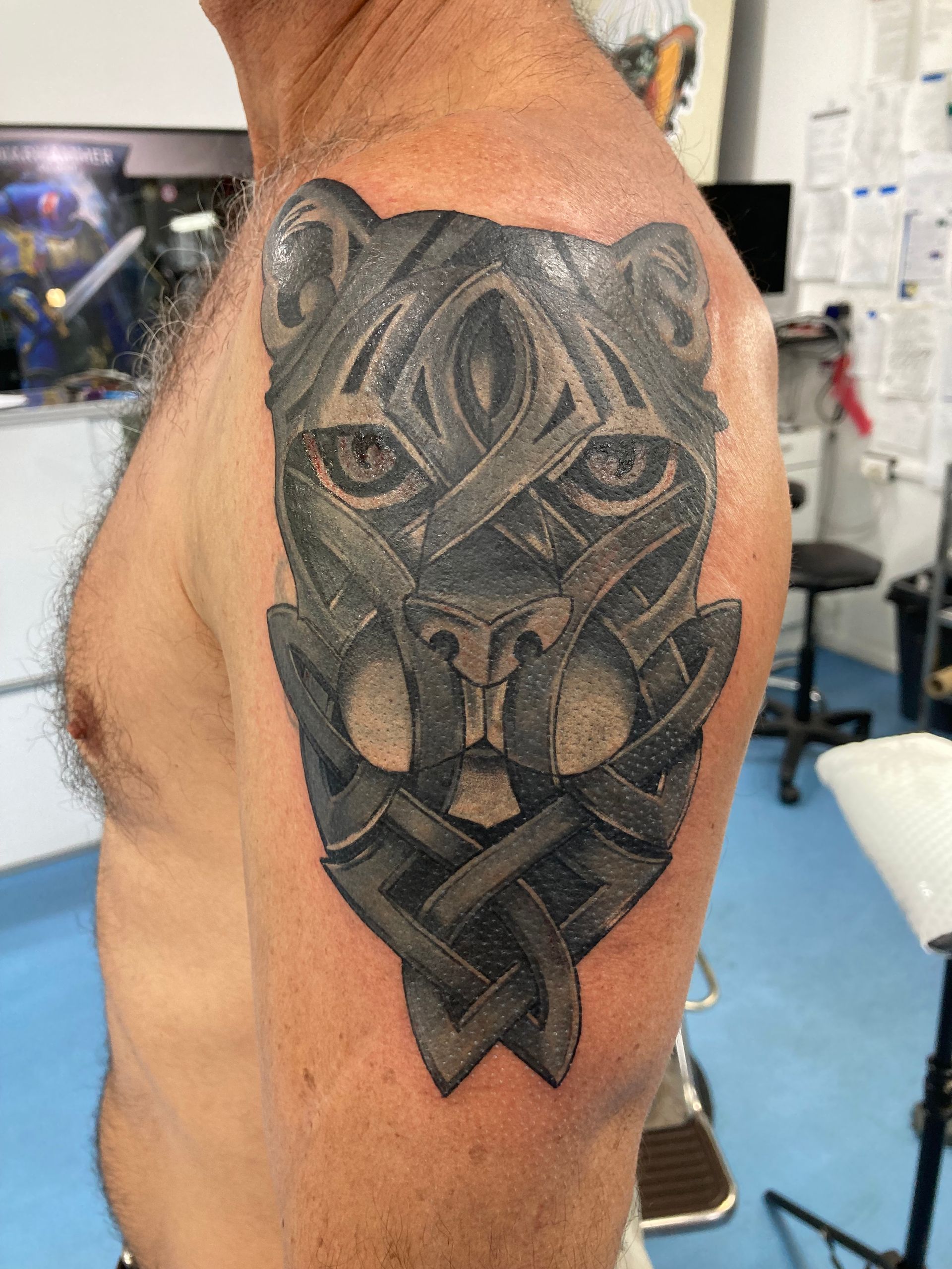 A Man Has a Tattoo of a Panther on His Shoulder — La Bomba Loca Tattoo in Cairns City, QLD