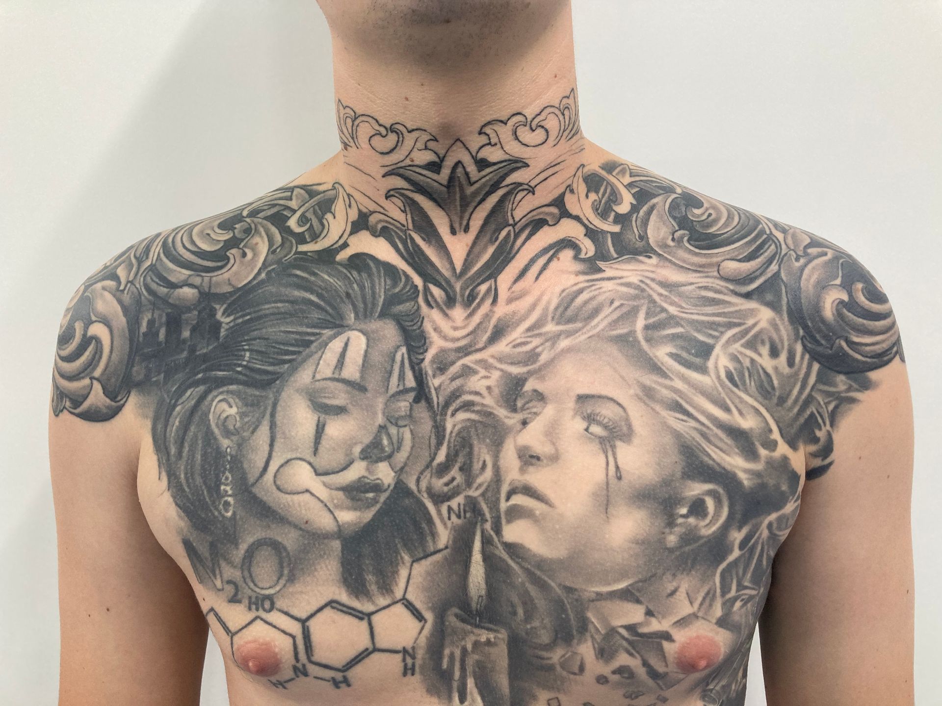 A Man Has a Tattoo of a Clown and a Woman on His Chest — La Bomba Loca Tattoo in Cairns City, QLD