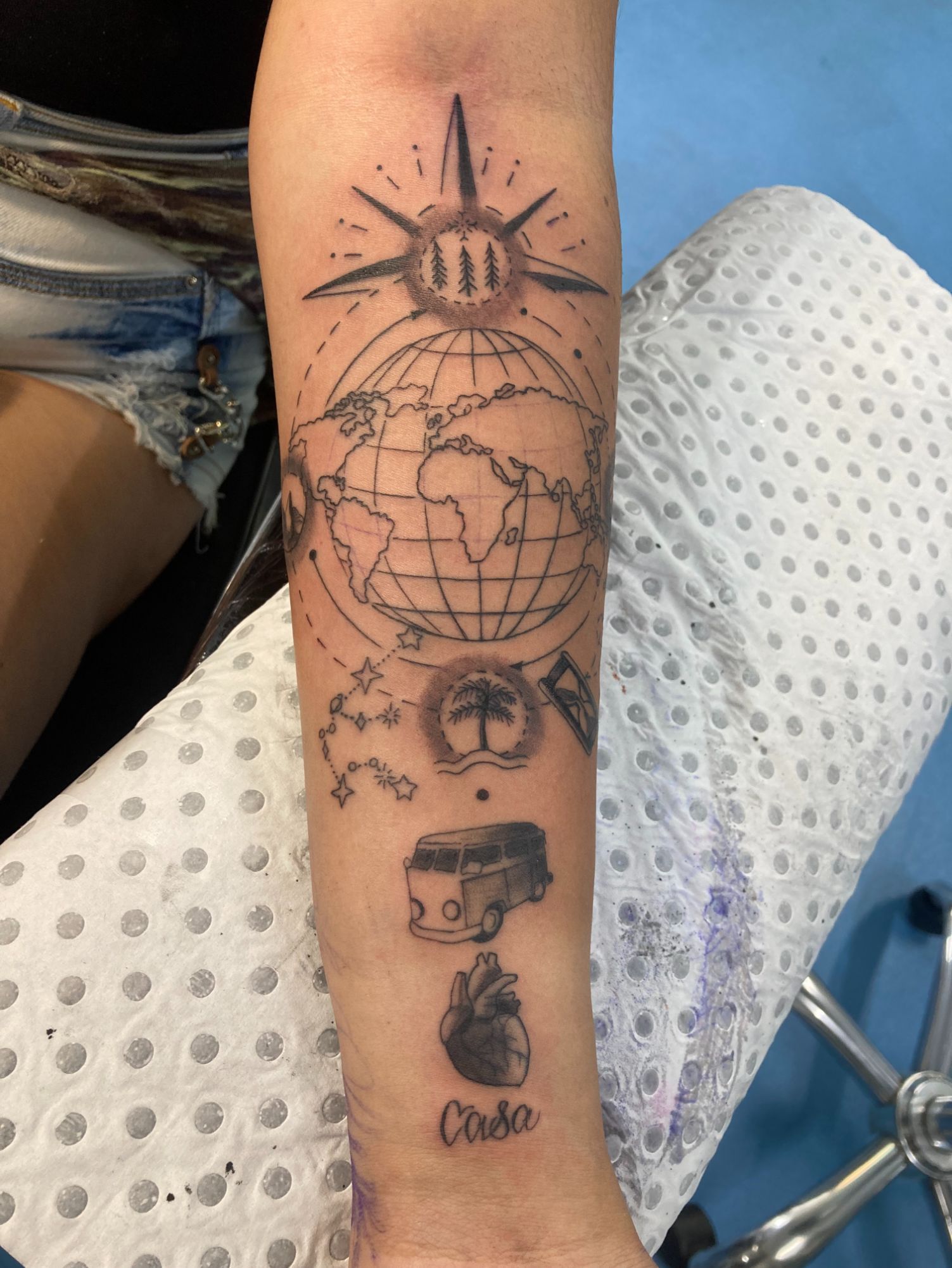 A Woman Has a Tattoo of a Globe on Her Forearm — La Bomba Loca Tattoo in Cairns City, QLD