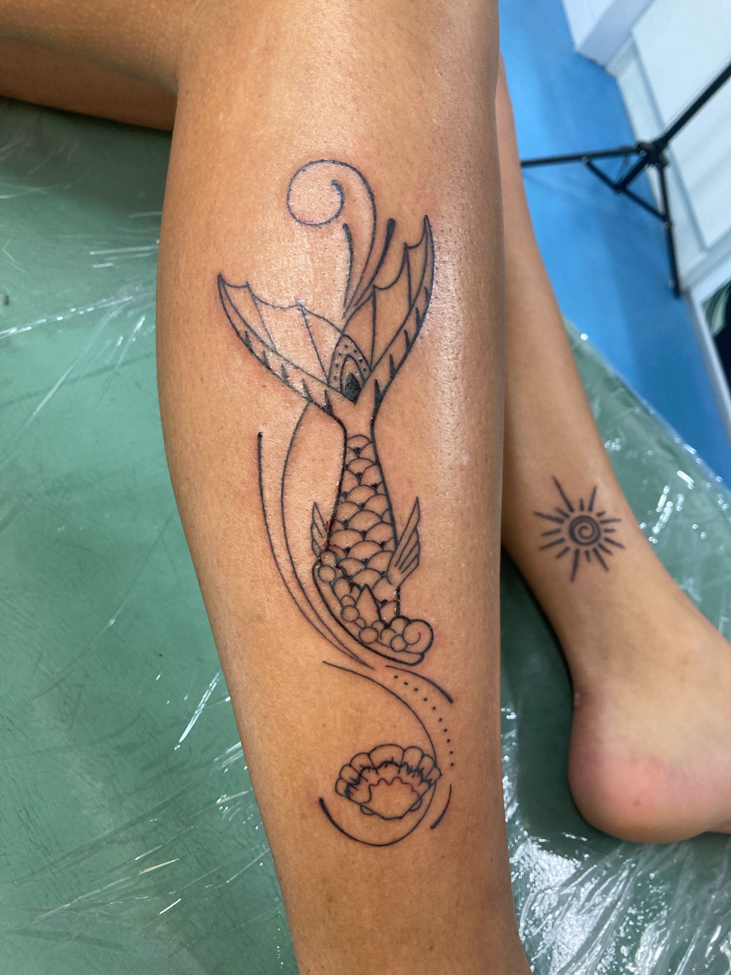 A Woman Has a Tattoo of a Mermaid on Her Leg — La Bomba Loca Tattoo in Cairns City, QLD
