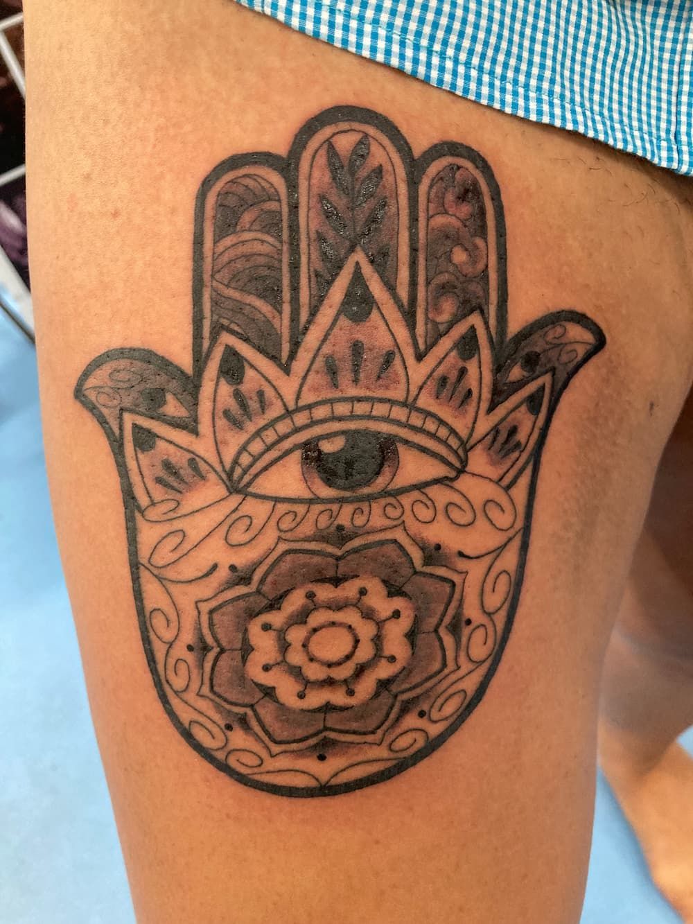 A Person Has a Hamsa Tattoo on Their Leg — La Bomba Loca Tattoo in Cairns City, QLD