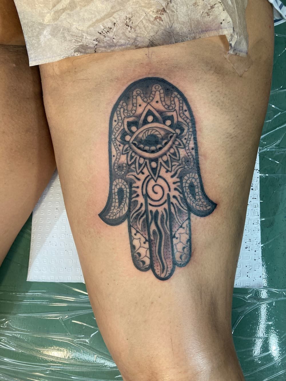 A Woman Has a Hamsa Tattoo on Her Leg — La Bomba Loca Tattoo in Cairns City, QLD
