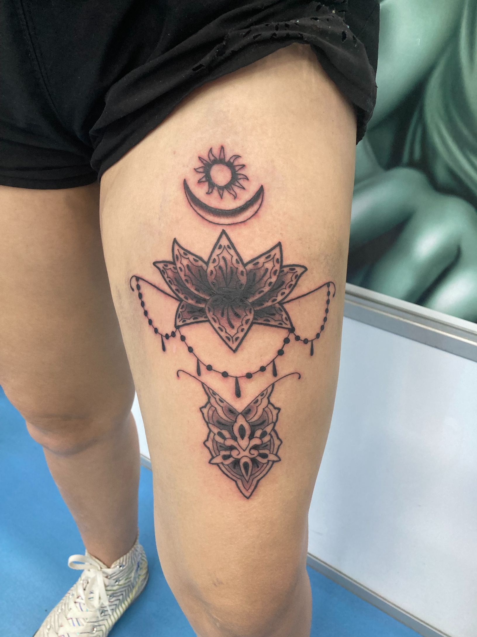 A Woman Has a Tattoo of a Lotus Flower on Her Thigh — La Bomba Loca Tattoo in Cairns City, QLD