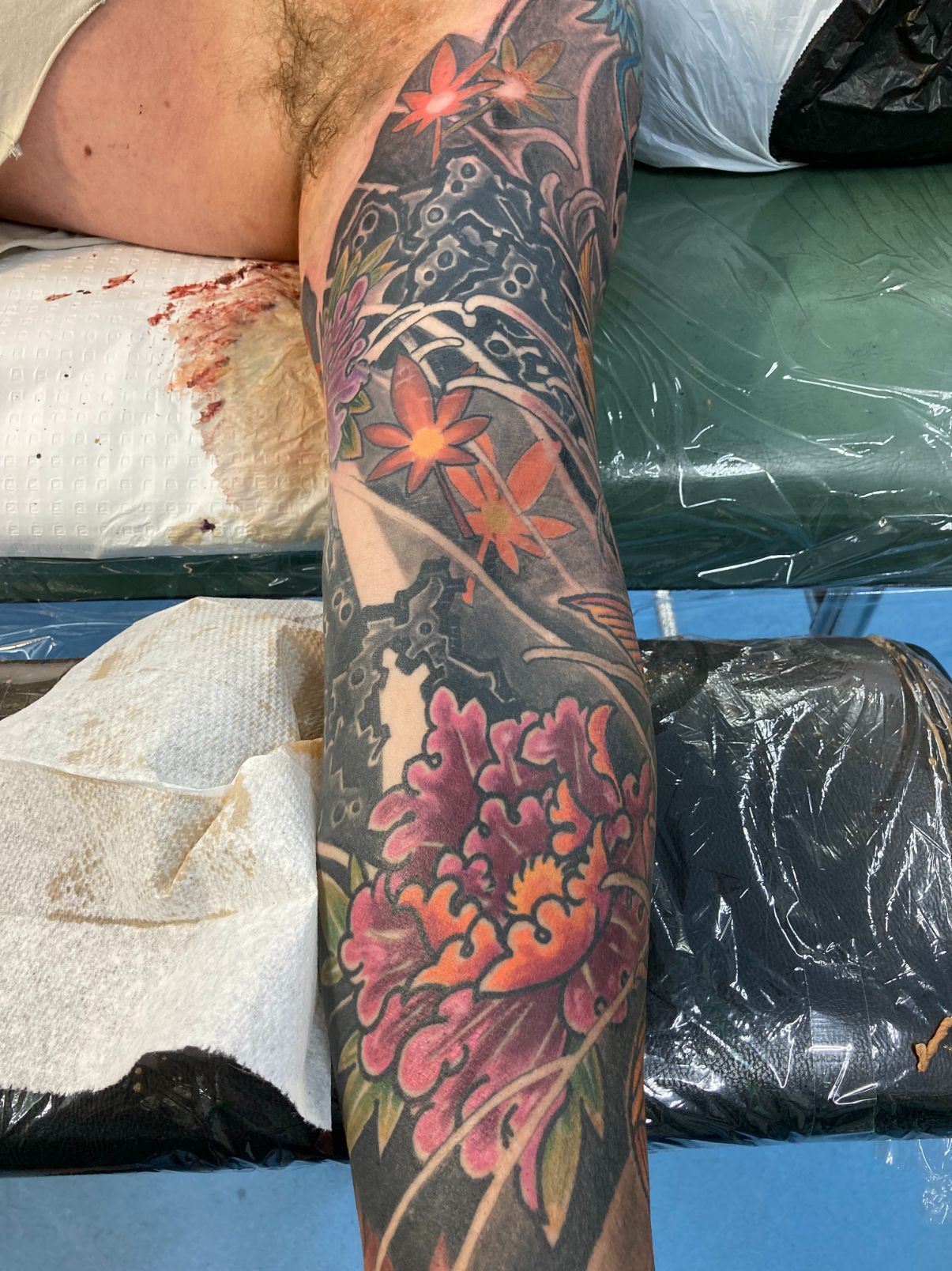 A Person Has a Tattoo of a Dragon on Their Leg — La Bomba Loca Tattoo in Cairns City, QLD