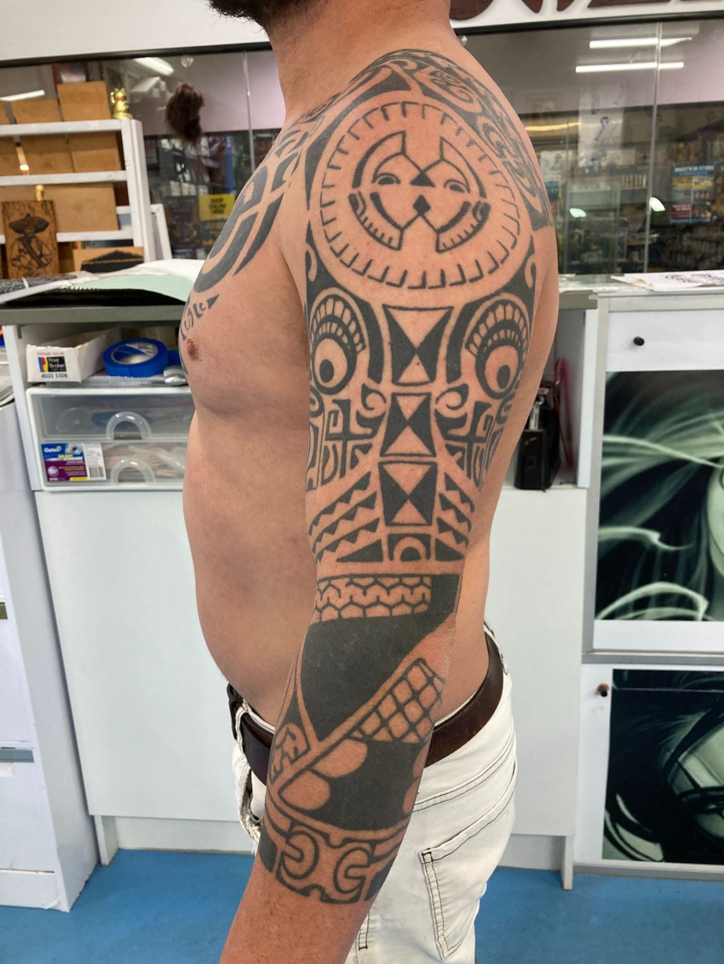 A Man Has a Large Tattoo on His Side Arm — La Bomba Loca Tattoo in Cairns City, QLD