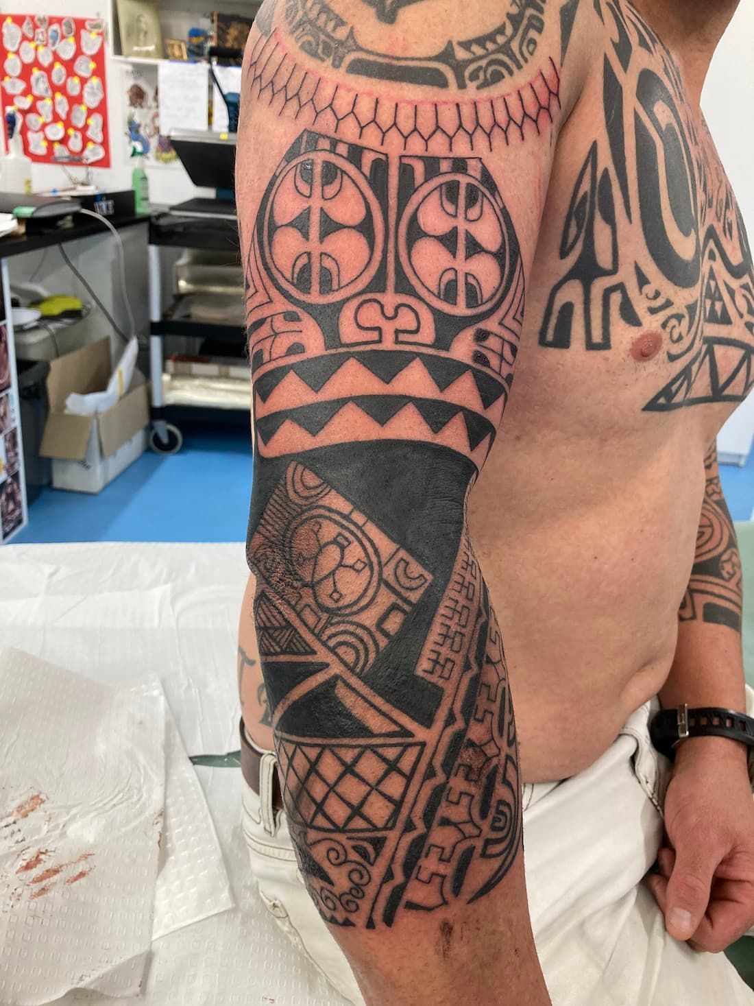 A Man Has a Tattoo on His Arm and Chest — La Bomba Loca Tattoo in Cairns City, QLD