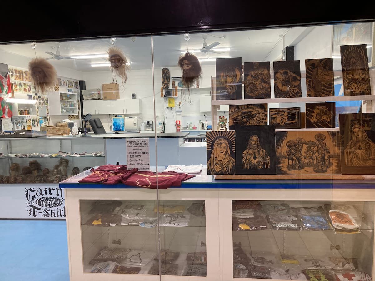 A Store Front With a Display Case Filled With Various Items — La Bomba Loca Tattoo in Cairns City, QLD