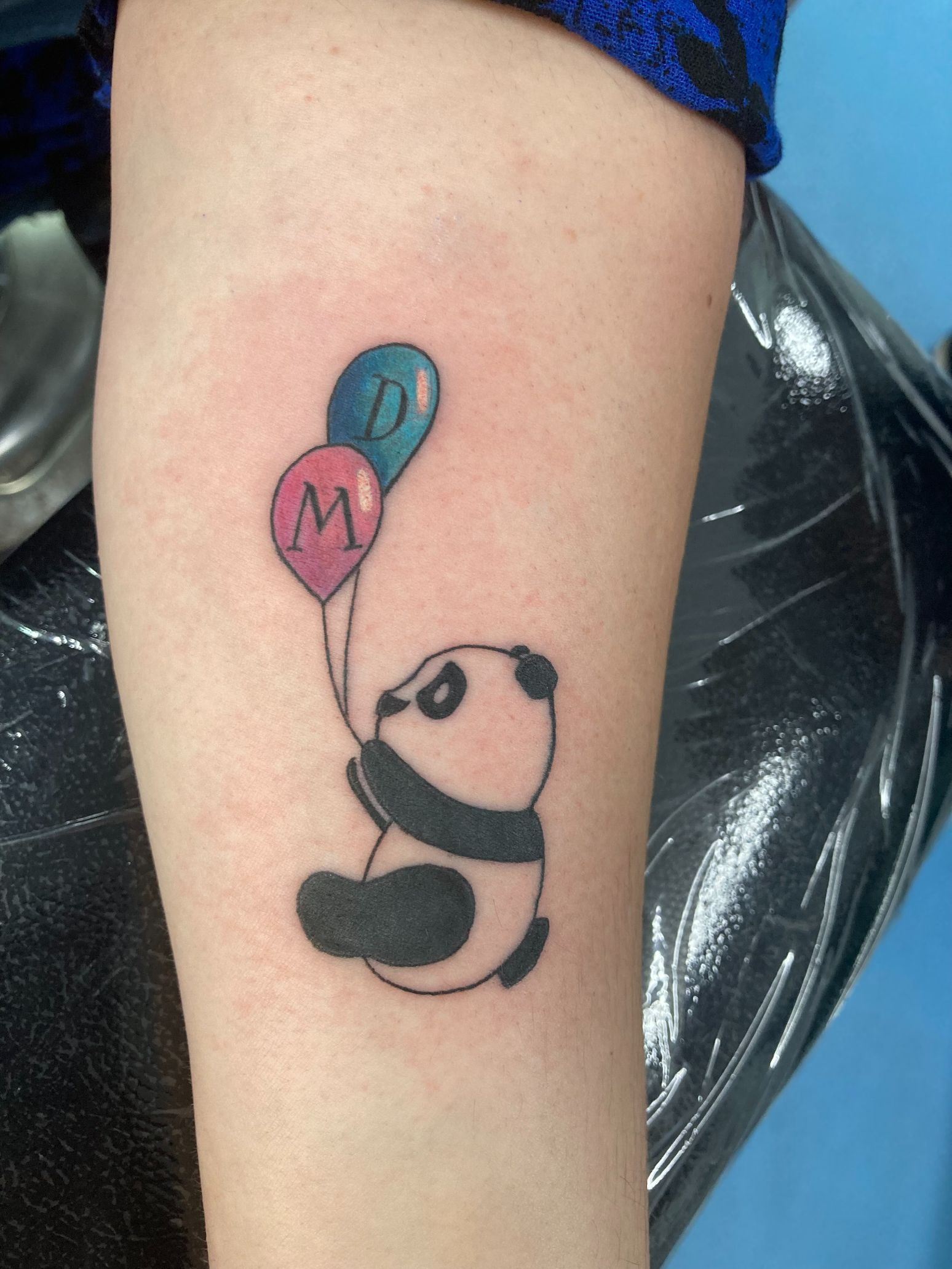 A Panda Bear is Holding Two Balloons With the Letter M on Them — La Bomba Loca Tattoo in Cairns City, QLD