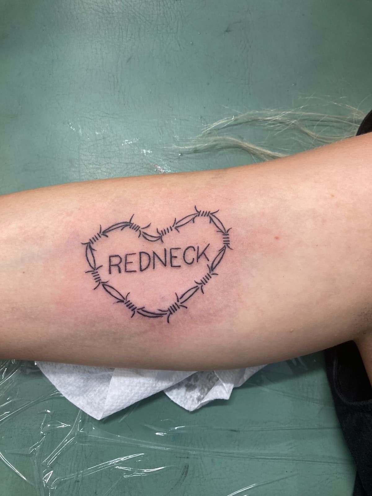 A Person Has a Barbed Wire Heart Tattoo on Their Arm — La Bomba Loca Tattoo in Cairns City, QLD