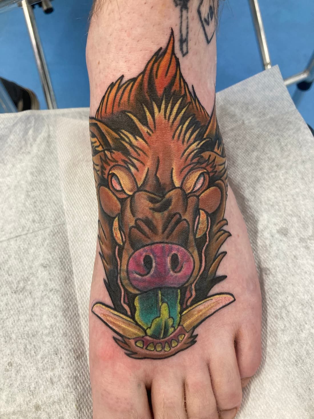 A Person Has a Tattoo of a Boar on Their Foot — La Bomba Loca Tattoo in Cairns City, QLD