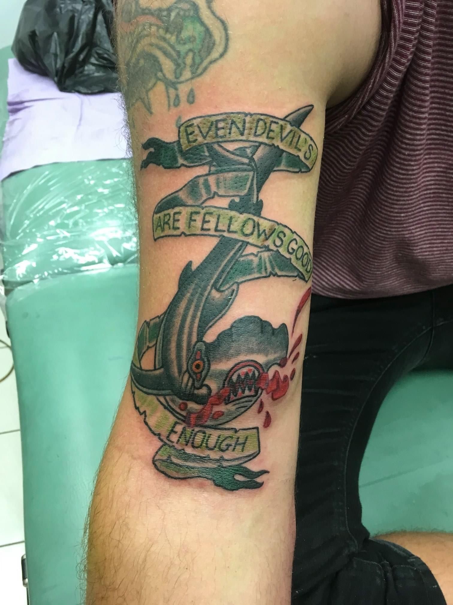 A Man Has a Tattoo on His Arm That Says Even Demons Are Fellows — La Bomba Loca Tattoo in Cairns City, QLD