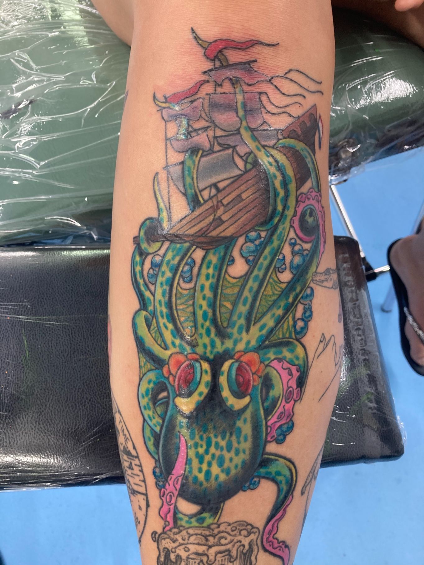 A Person Has a Tattoo of an Octopus and a Ship on Their Leg — La Bomba Loca Tattoo in Cairns City, QLD